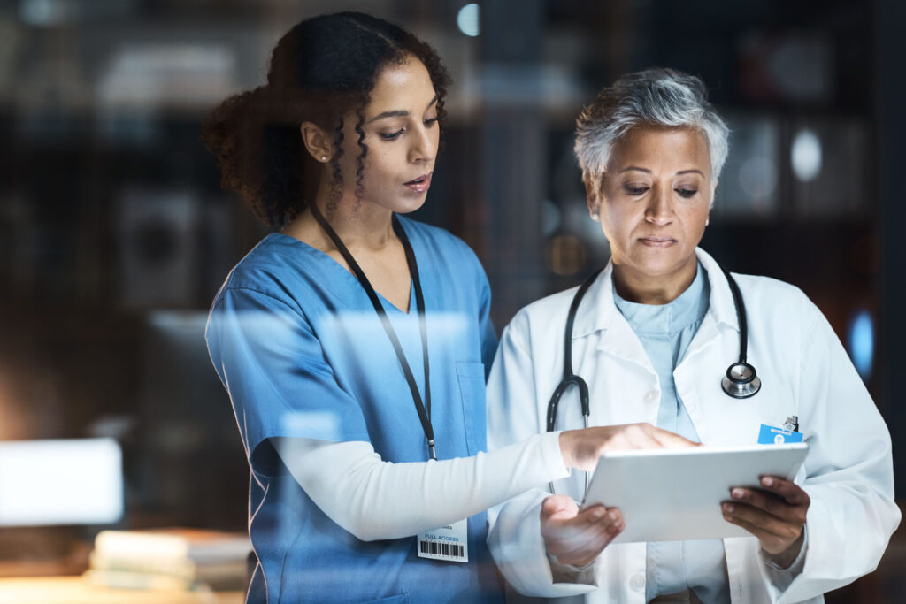 Doctor and nurse reading digital device